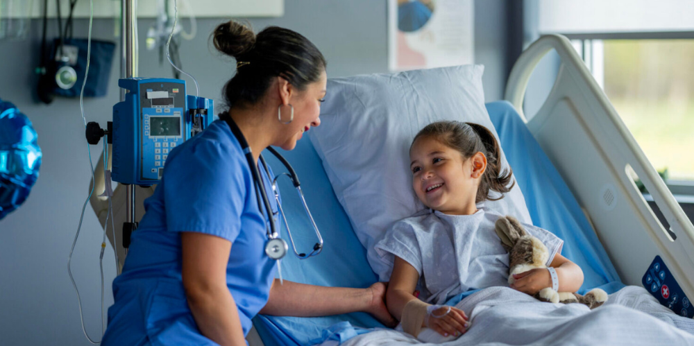 Doctor sharing a laugh with a child that is a patient