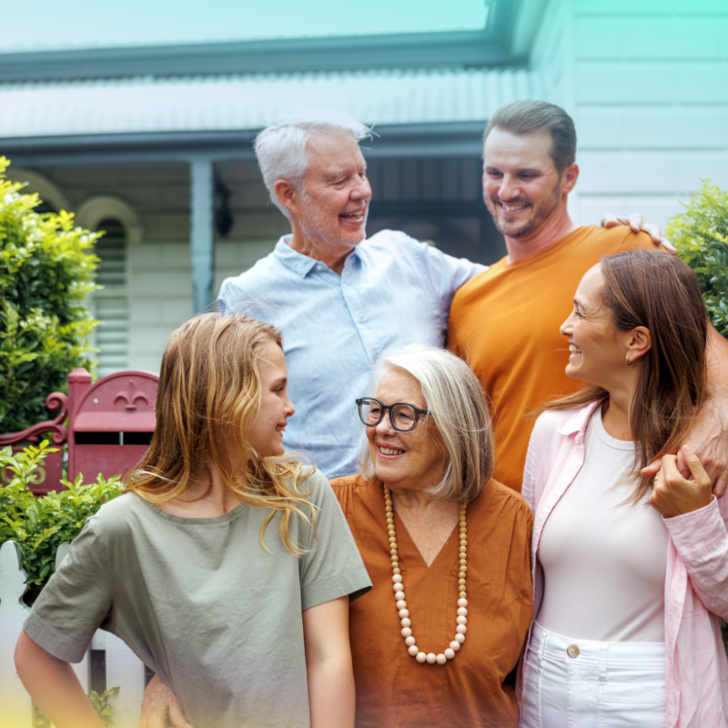 A family smiling outside their home