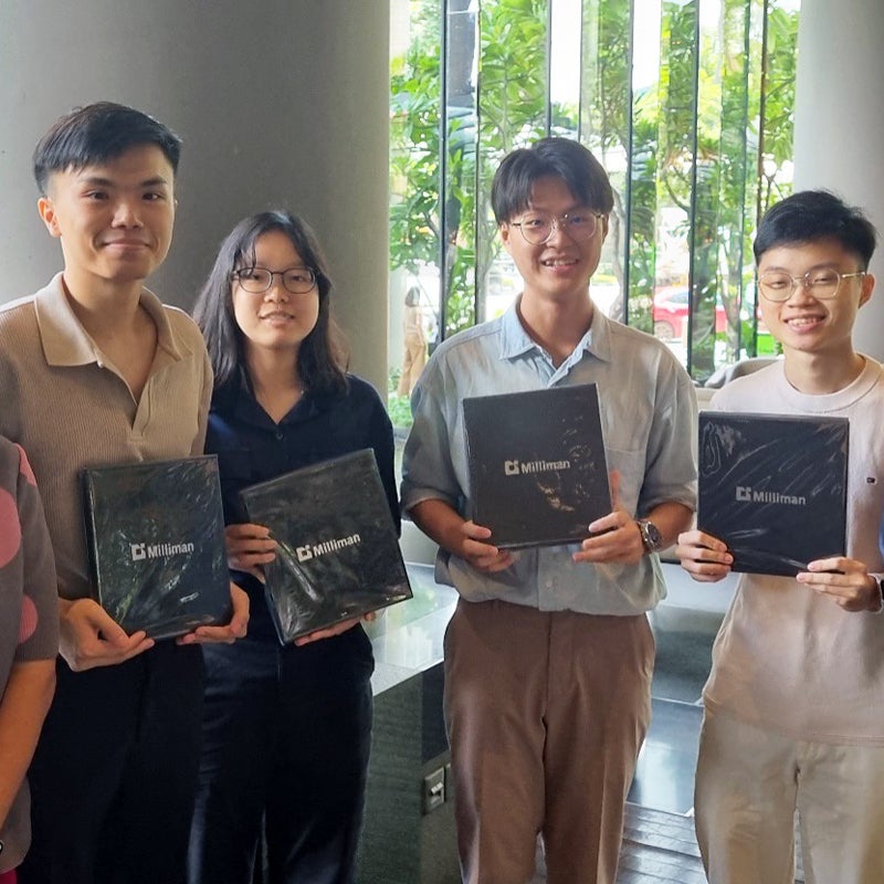 Four young actuaries standing holding their Innovation Challenge award from 2024.
