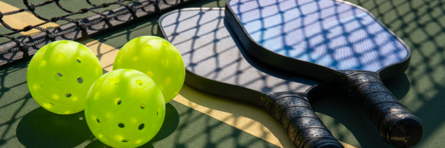 A paddle and pickleball. 