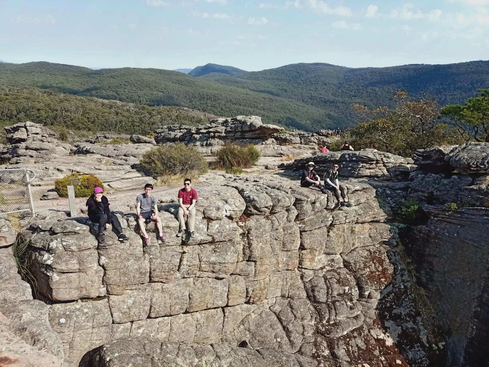 Garvin (third from left) sitting on a ledge at the Grampians.