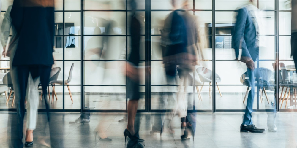 busy office space, blurred workers 