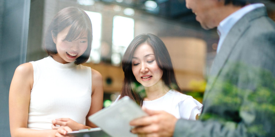 People discussing the content on a device.