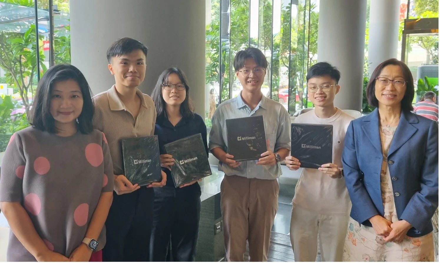 Wen Yee Lee, Principal at Milliman Singapore office, MinionMan and Professor Jun Yang, Dean of Business at NBS.