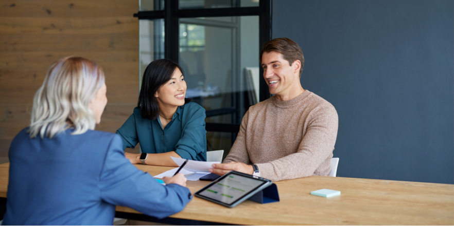Smiling multiethnic couple receiving financial guidance from advisor