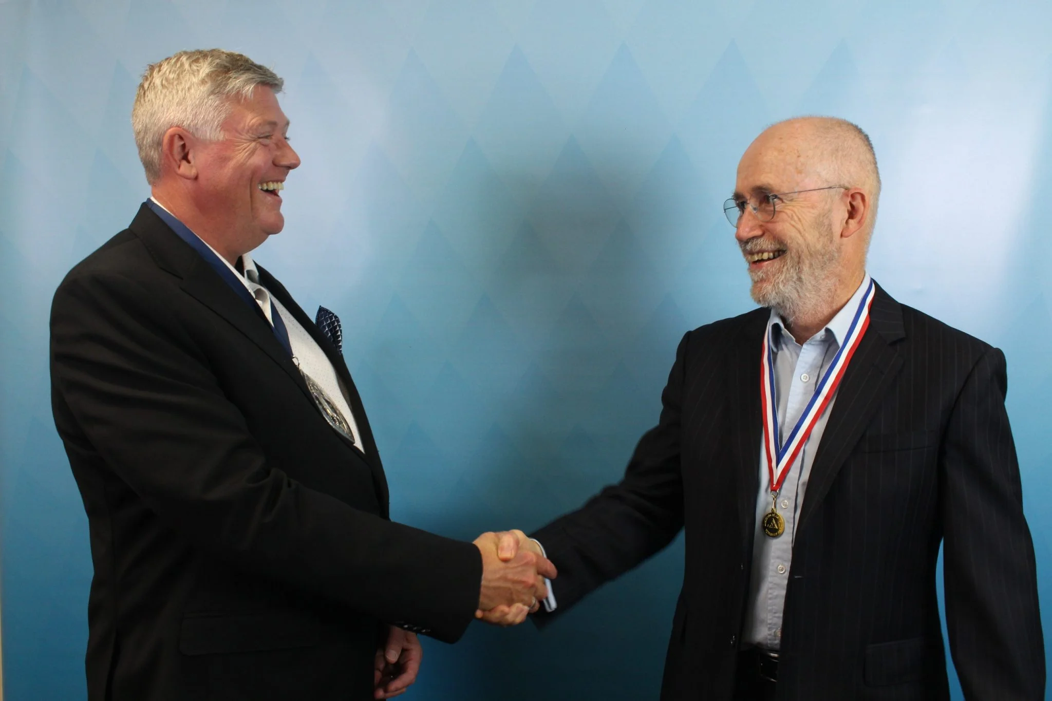 President Jefferson Gibbs presenting Ian with the Gold Medal at the Council meeting on 2 December 2021.