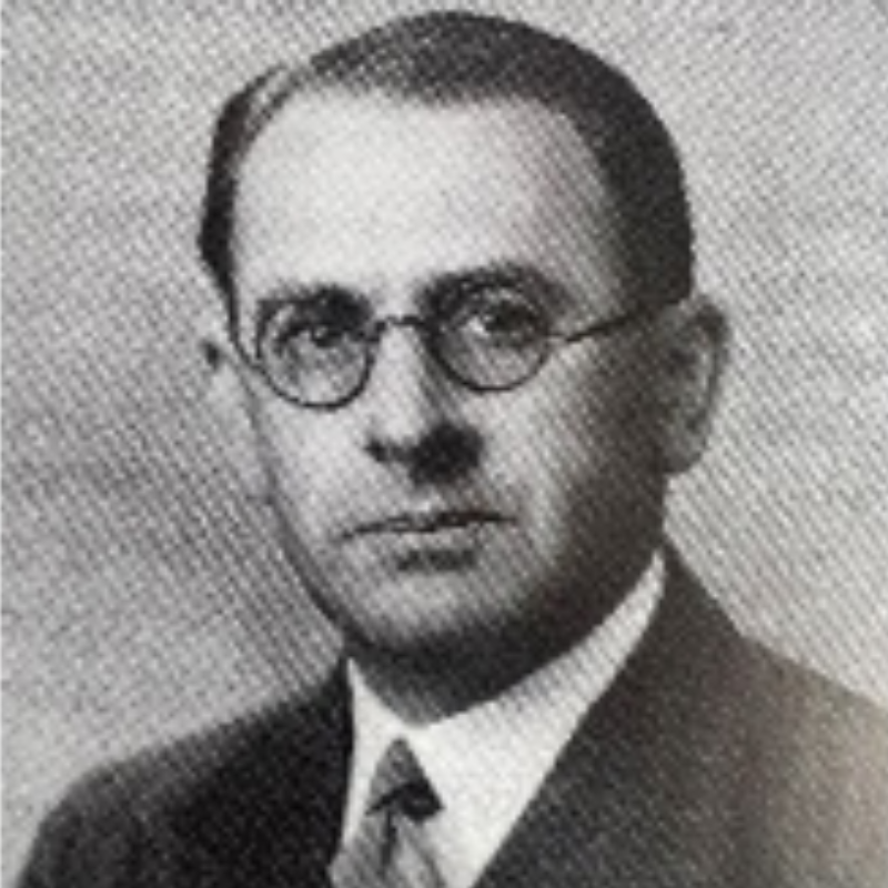 A black and white photo of a professional man wearing glasses.