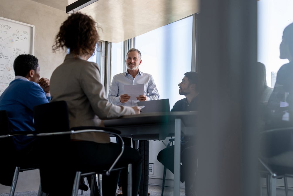 Man presenting to a room of people