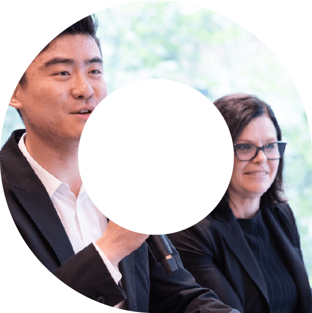 A man and a woman at a conference event within a viewfinder shape