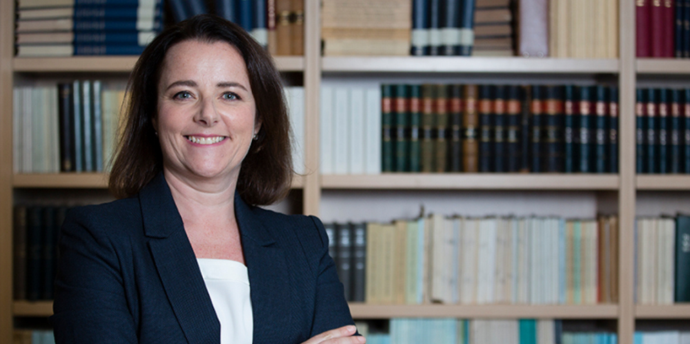 A photo of Actuaries Institute CEO Elayne Grace in a library