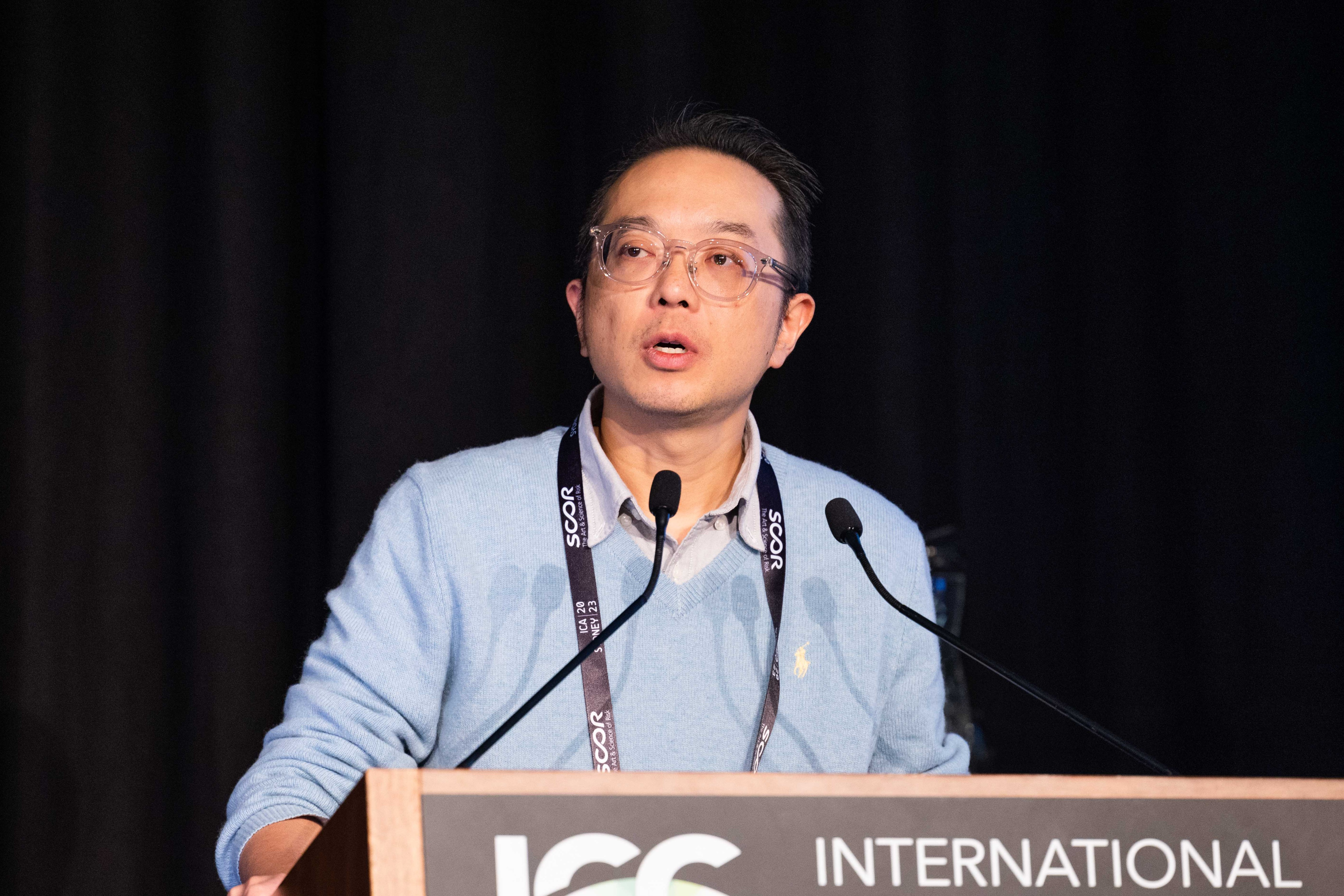 Louis Lee presenting at the 2023 International Congress of Actuaries in Sydney, Australia