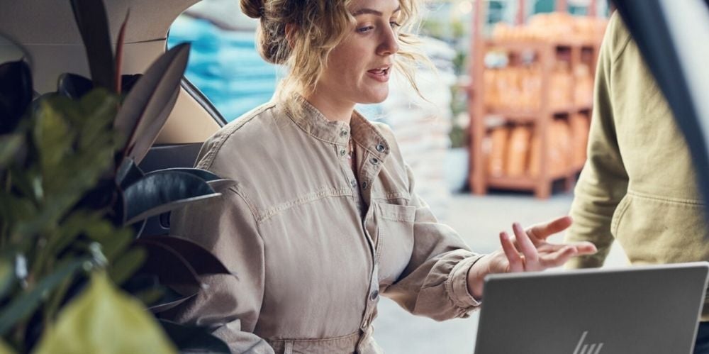 Woman with blonde hair at desk with laptop