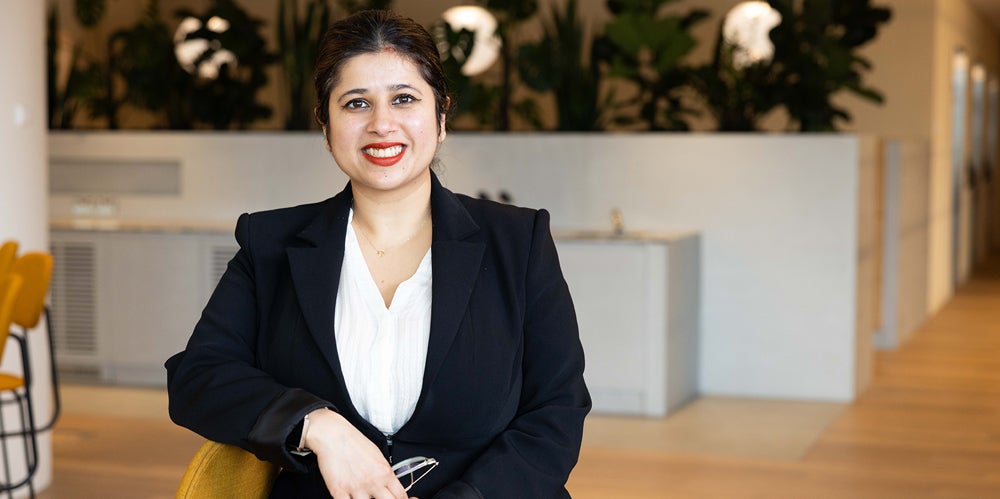 Female actuary wearing suit smiling