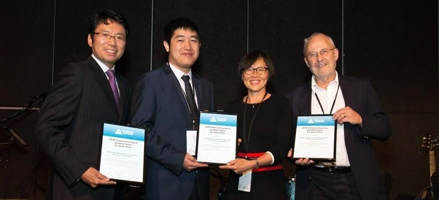 Value statement: Greg (R) receiving the Actuaries Institute Taylor Fry Silver prize at the 2018 General Insurance Seminar.