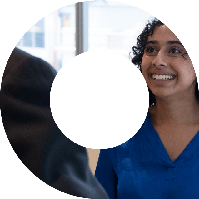 A young woman in blue shirt smiling within a viewfinder shape