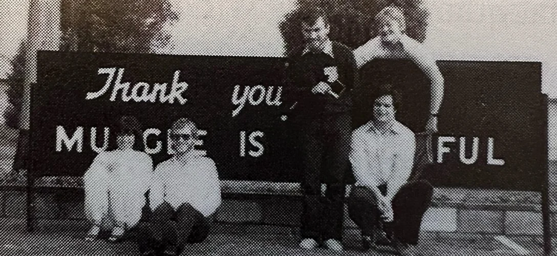 Some unidentifiable MUGS sitting in front of the 'Mudgee is Beautiful' sign.