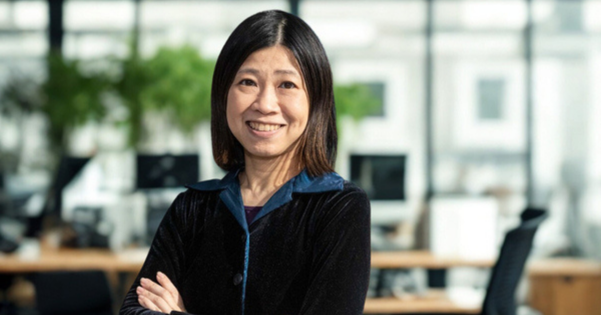 A photo of 2025 Actuary of the Year Iris Lun in a office with her arms crossed