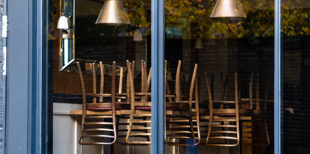 Chairs on the tables of a restaurant forced to close during lockdown to control COVID-19 pandemic