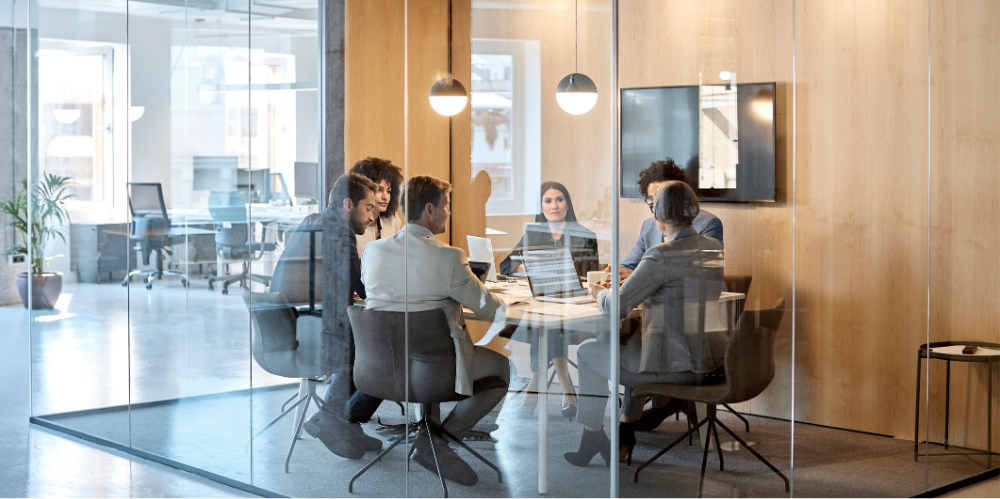 Multi-ethnic coworkers discussing in board room at office 