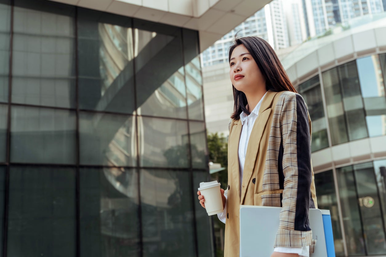 Happy successful asian businesswoman ready for her job interview or first day at work .
