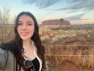 A photo of Sophia visiting Uluru on one of adventures.