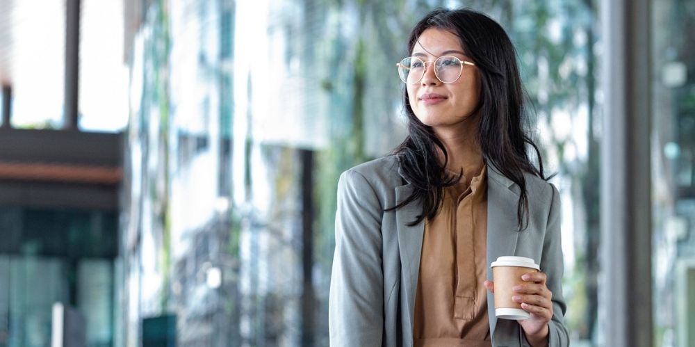 Women with coffee in hand.