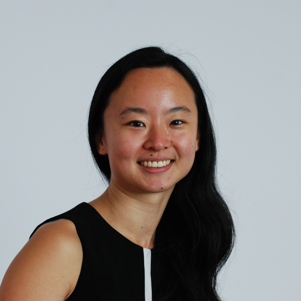 Female smiling at camera with black sleeveless dress on