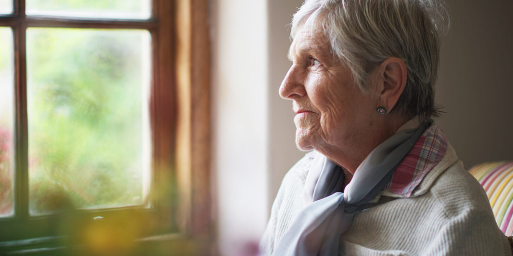 Elderly woman staring out the window