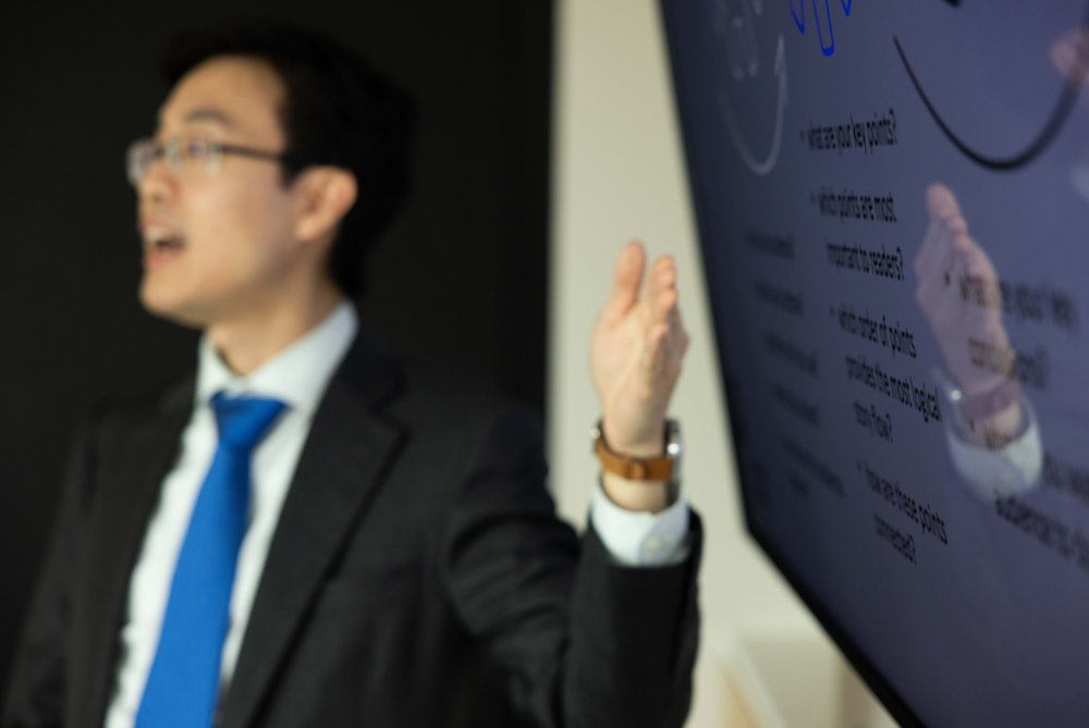 Professional man presenting at screen.