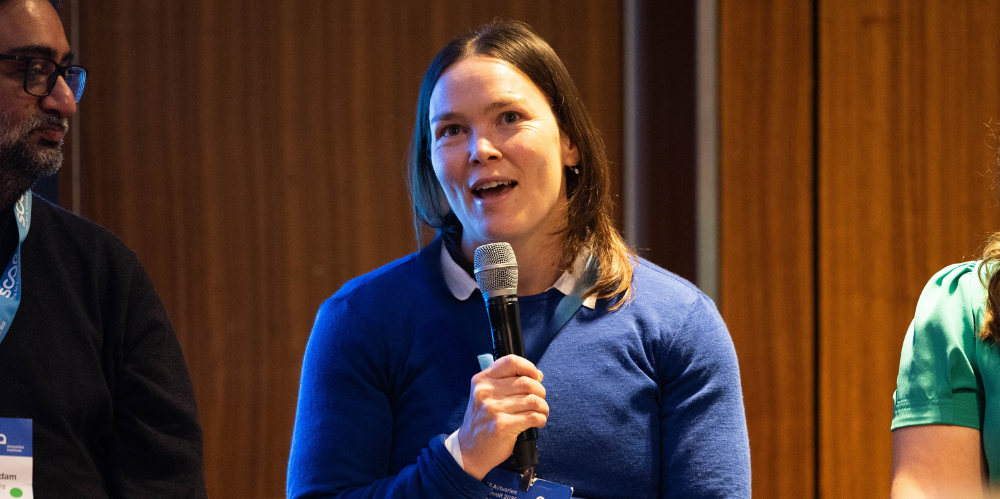 Female speaker with microphone.
