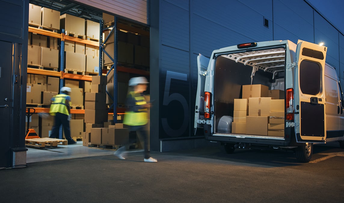 Workers filling up truck with parcels