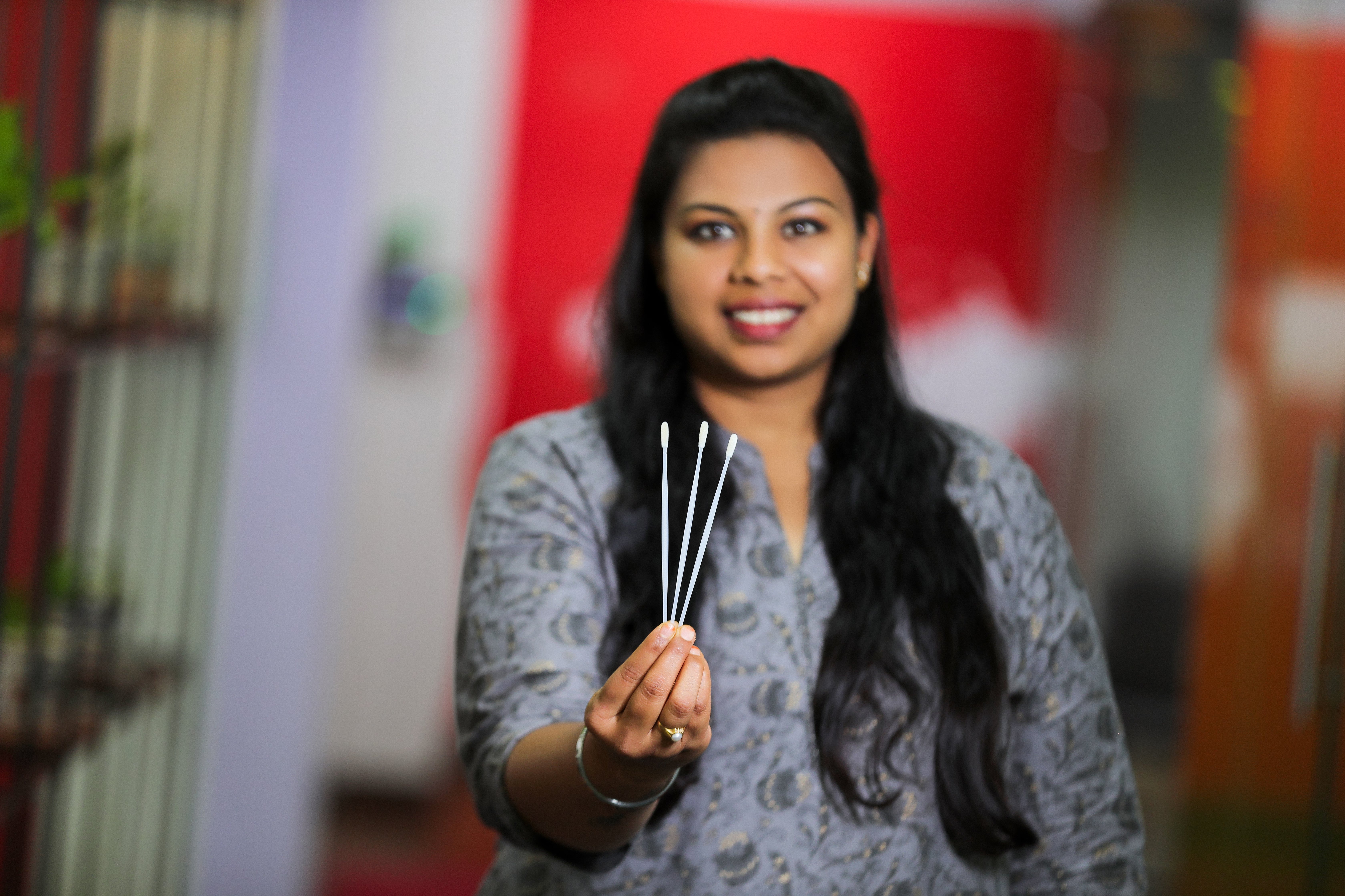 Anusha holding the swabs