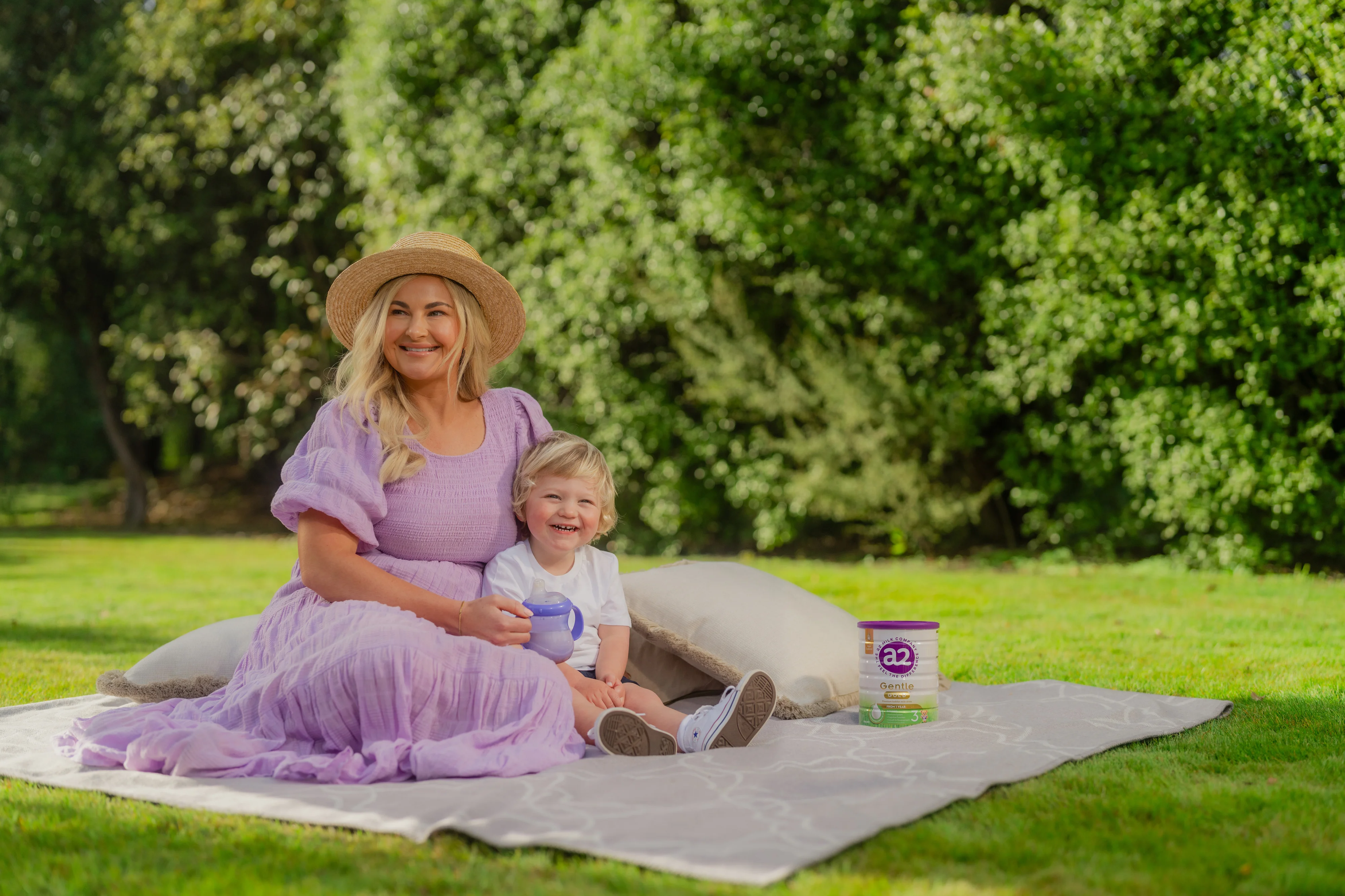 a2 Gentle Gold® tin range and fresh milk on picnic table