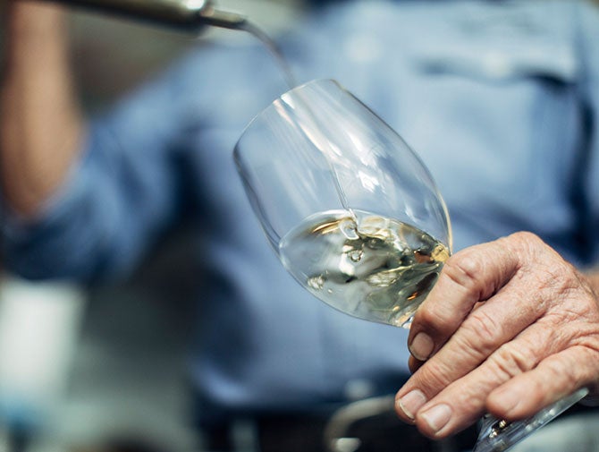 Pouring white wine into glass