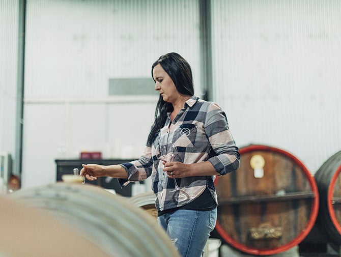 Janelle Zerk testing wine from barrels