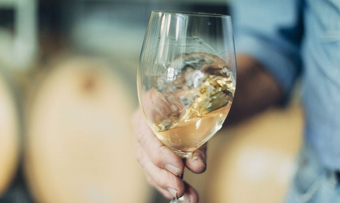 White wine swirled in glass