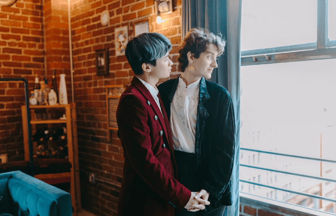 A mid-shot of a couple dancing - they both look out the window as they think about upcoming Christmas. 