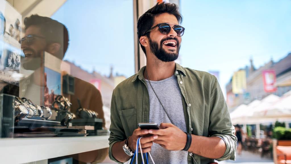 Man uses his phone while out shopping