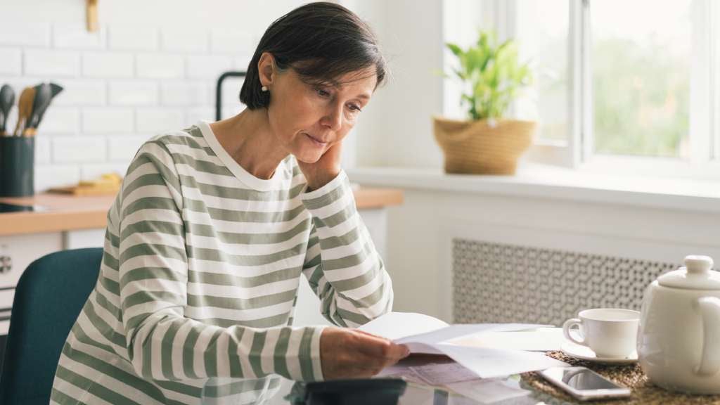 woman looking over documents looking stressed