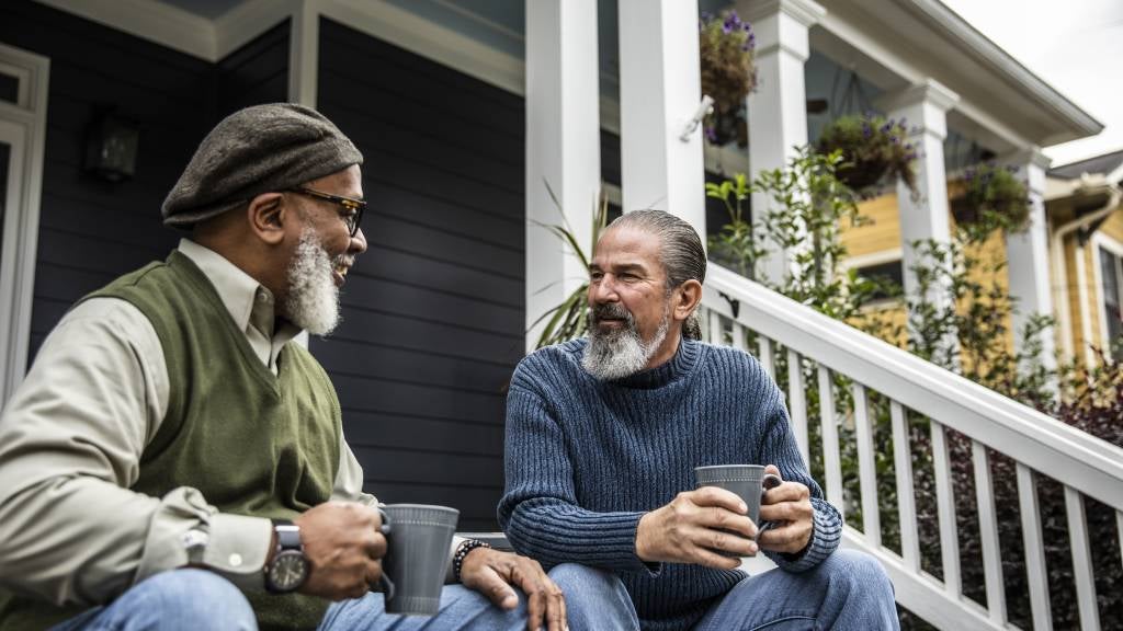 Two senior men catching up over coffee