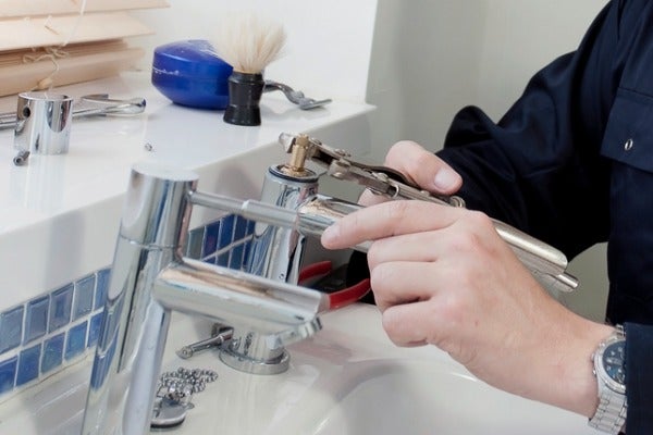 使用扳手工具將水龍頭裡面受損的零件取出