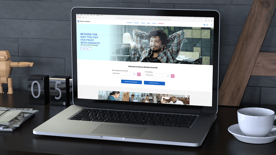 Konica Minolta | homepage on laptop | Devotion