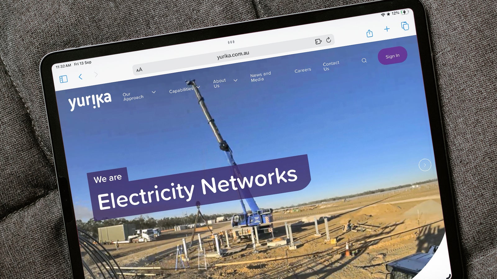 Yurika | An iPad lying on a couch showing the Yurika website's homepage | Devotion