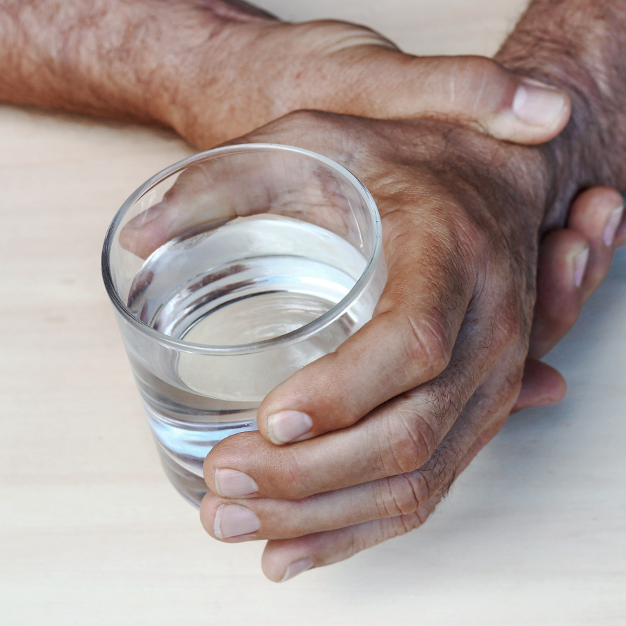 Hands holding glass of water