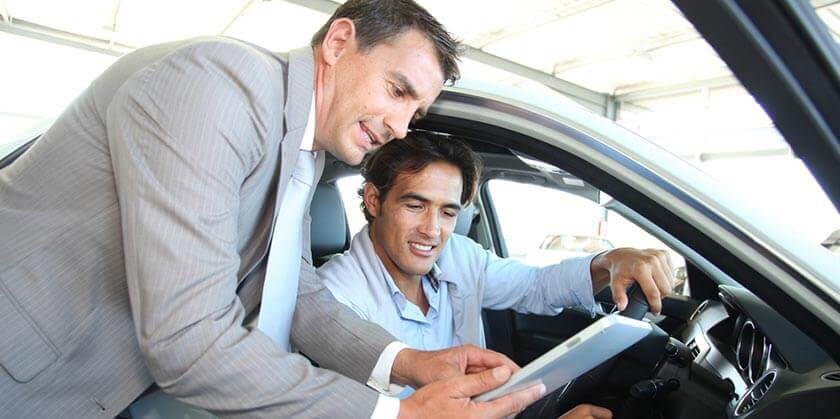 customer discussing insurance options at car dealer