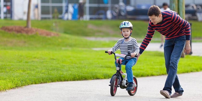 dad following son on bike