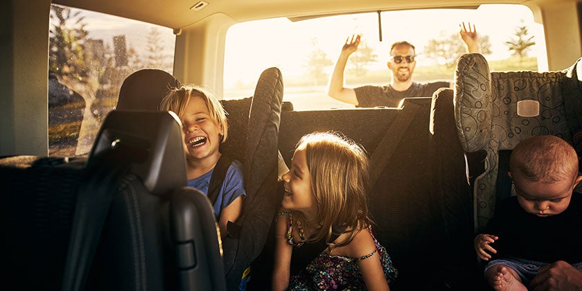 young kids in car with family