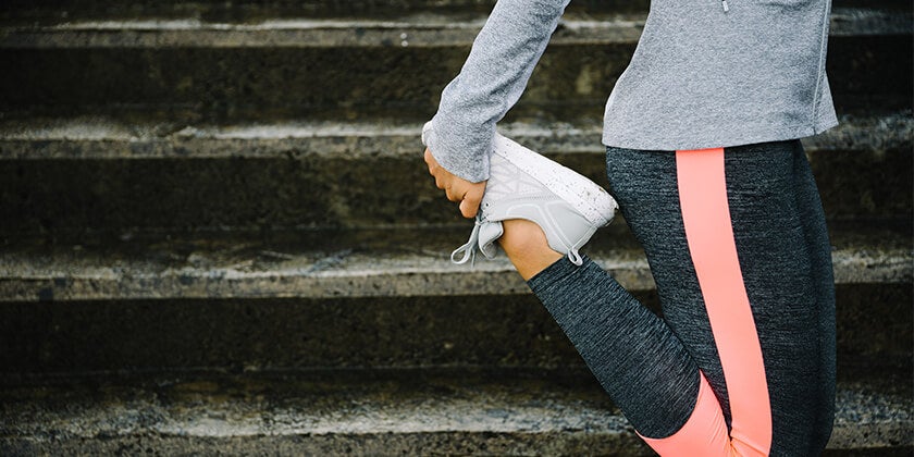woman running and stretching