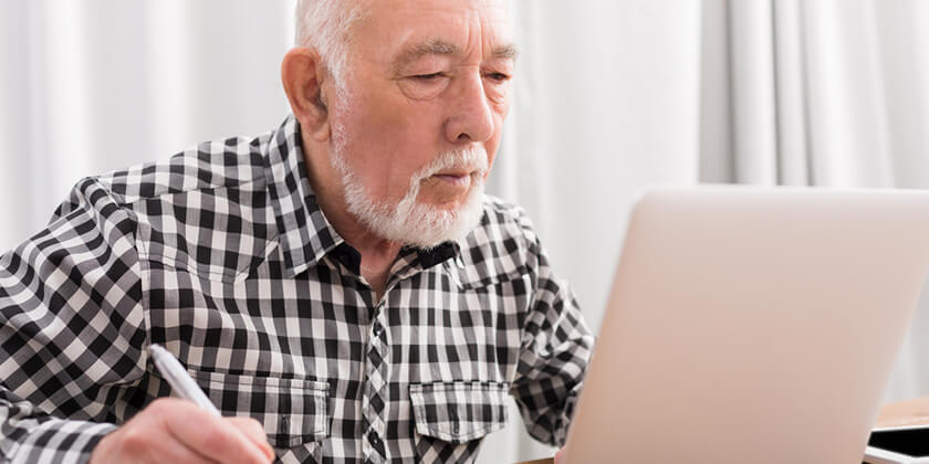 older man using computer