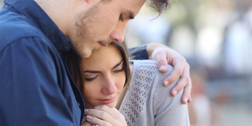 young man and woman comforting each other